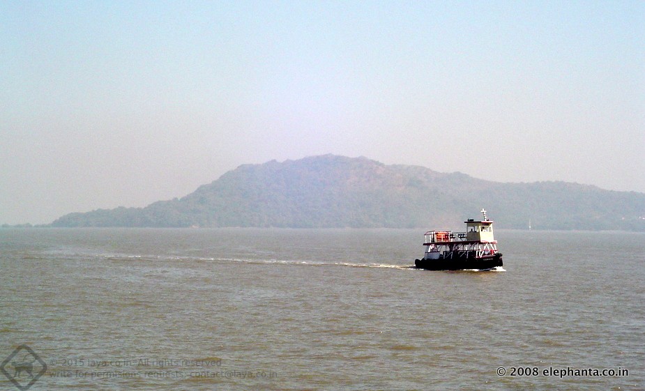 Ferry returning to Mumbai from Elephanta. The Elephanta Island in the backdrop. 